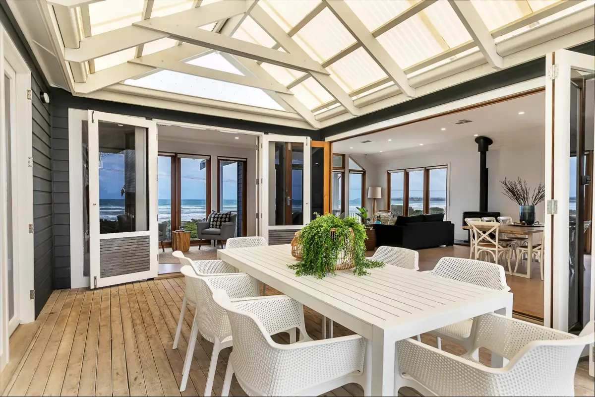 Covered deck with a white dining table
