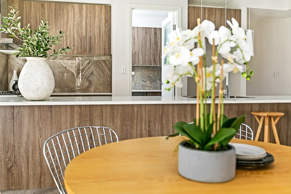 Dining table with orchids and a timber feature wall