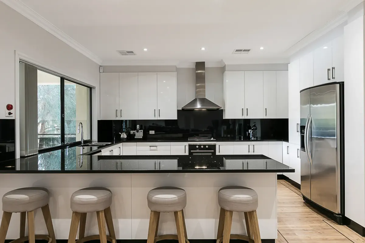 Dark-toned kitchen photographed for a listing, verticals straightened by FotoPal