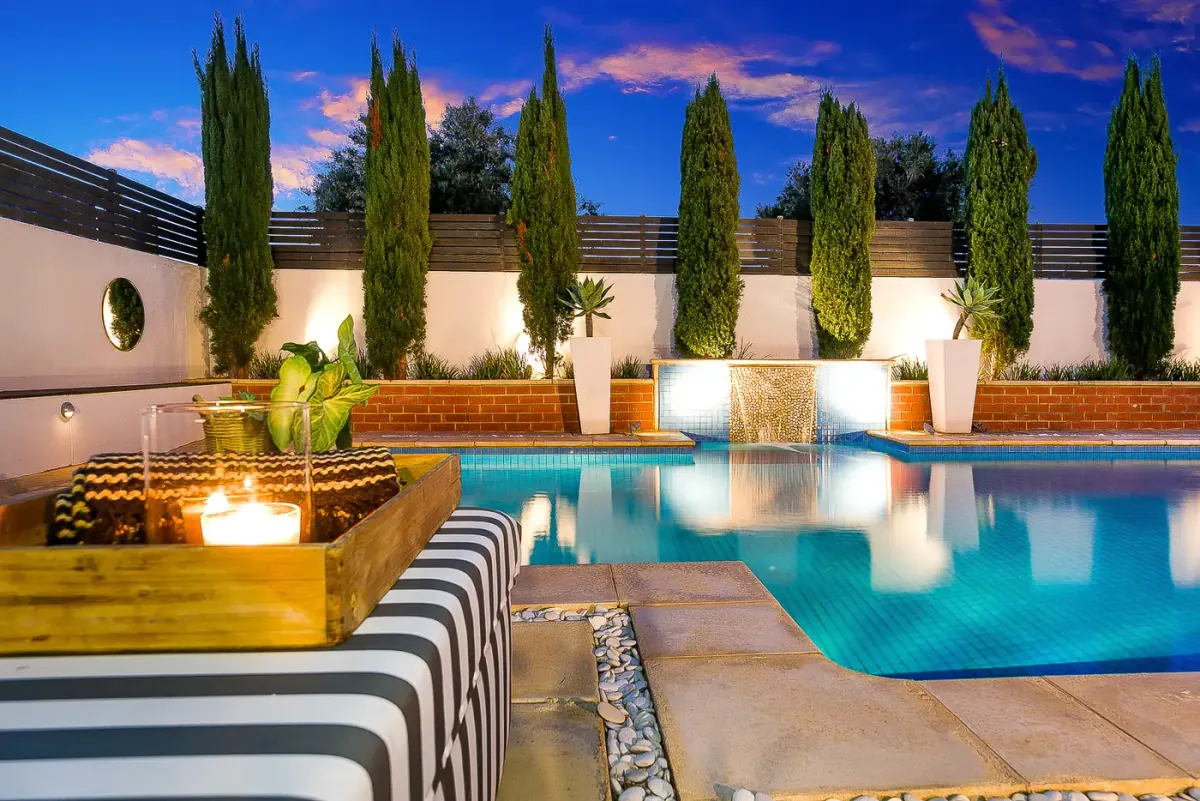 Twilight real estate photo of a courtyard with the house lit, delivered in a branded FotoPal gallery